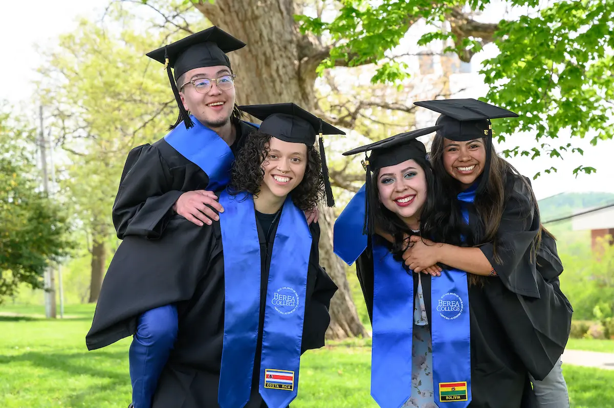 Four graduates pose for image after graduation at Berea College