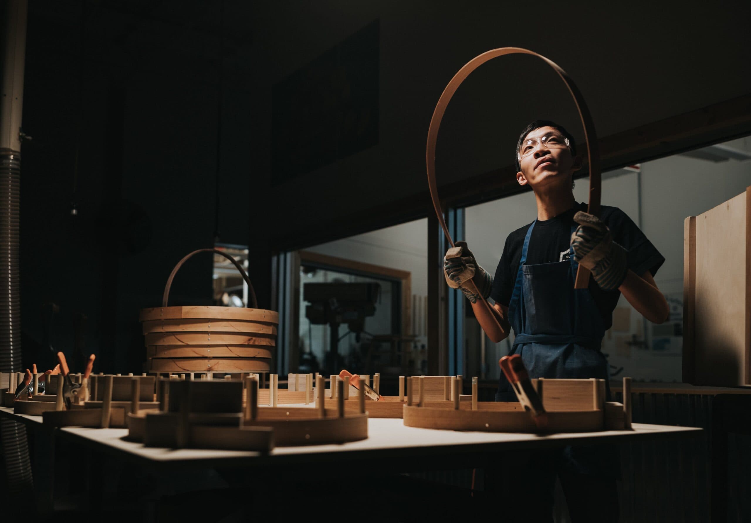 Wood working student in Student Craft shaping wood for a basket