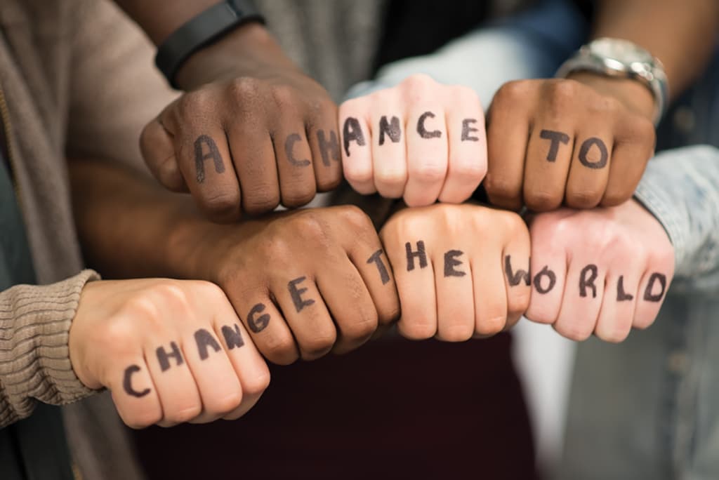 Multi-racial hands with the words A Chance to Change the World written across them