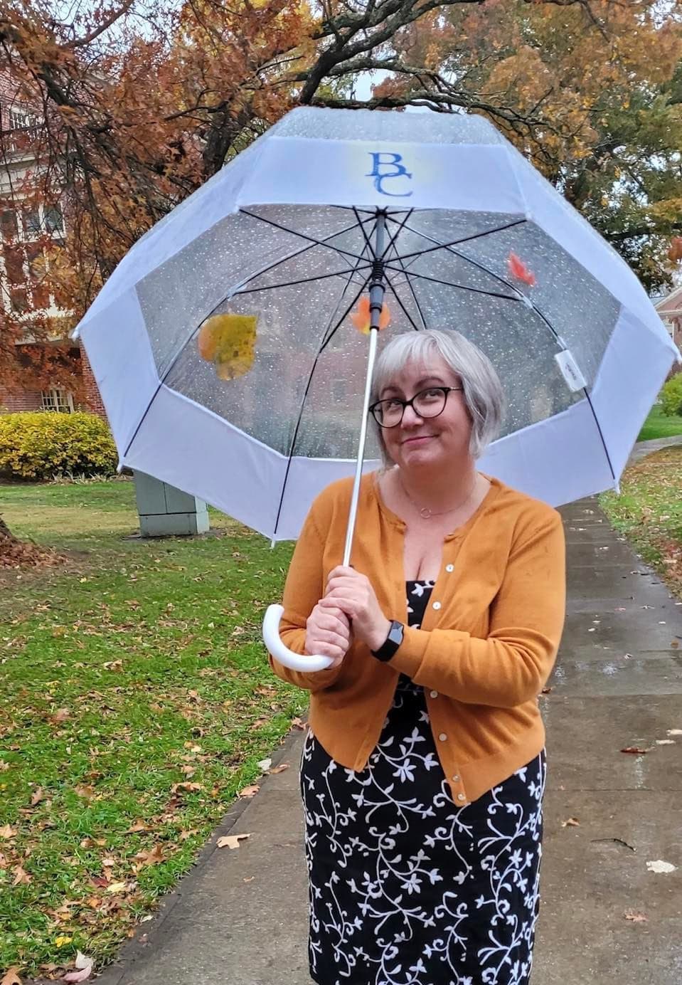 Portrait of Amanda Peach holding an umbrella