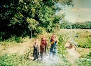 Charity and her two brothers helping in the garden