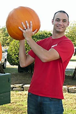 Photo of Dr. Jacob Dickerson holding a large pumpkin