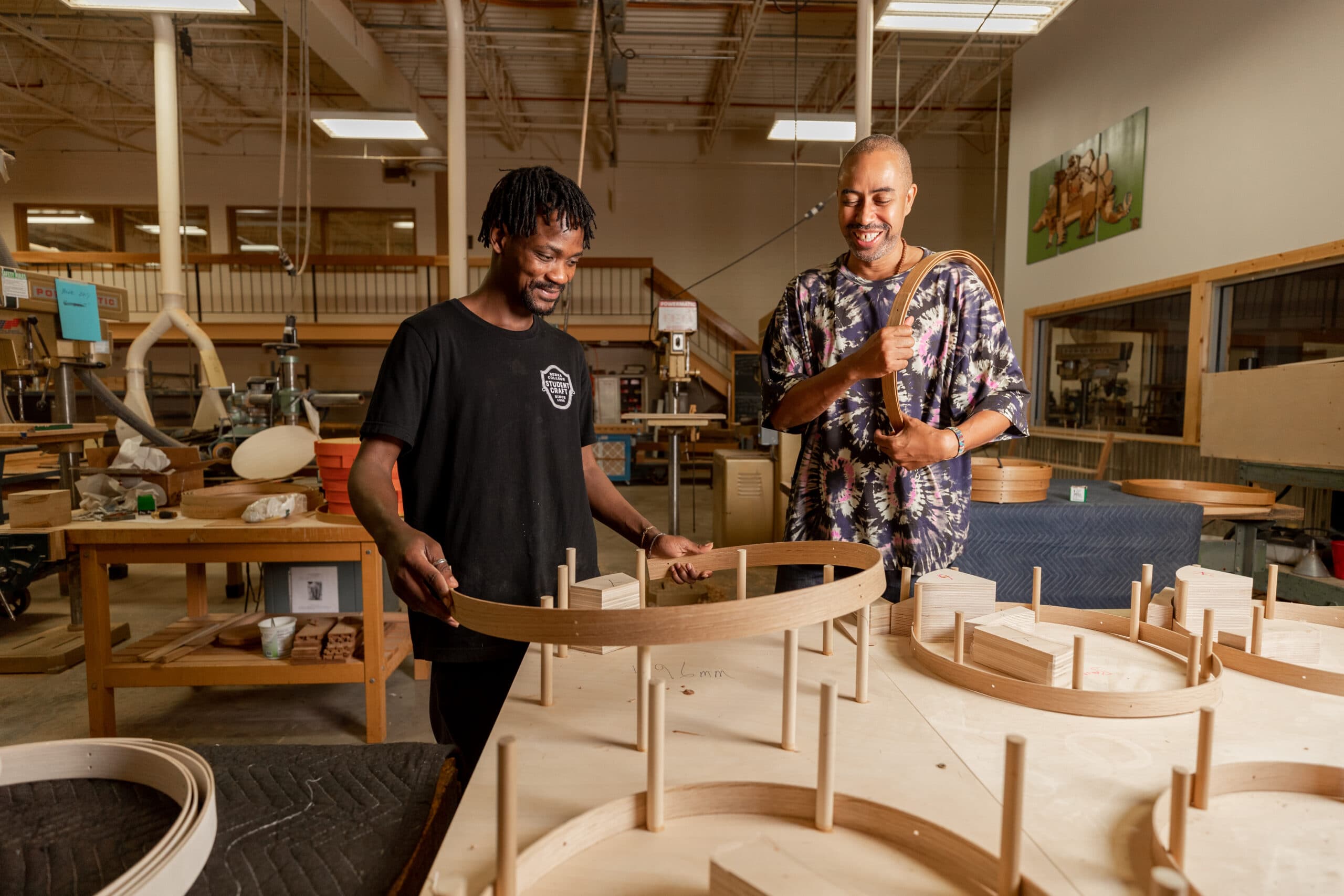 Berea College craft student woodworking with designer Stephen Burks