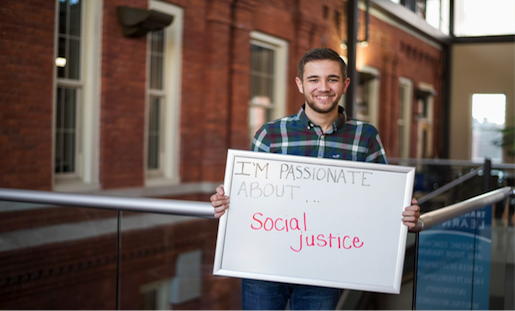 Jackie Malone '18 holds a sign that says "I'm passionate about social justice"