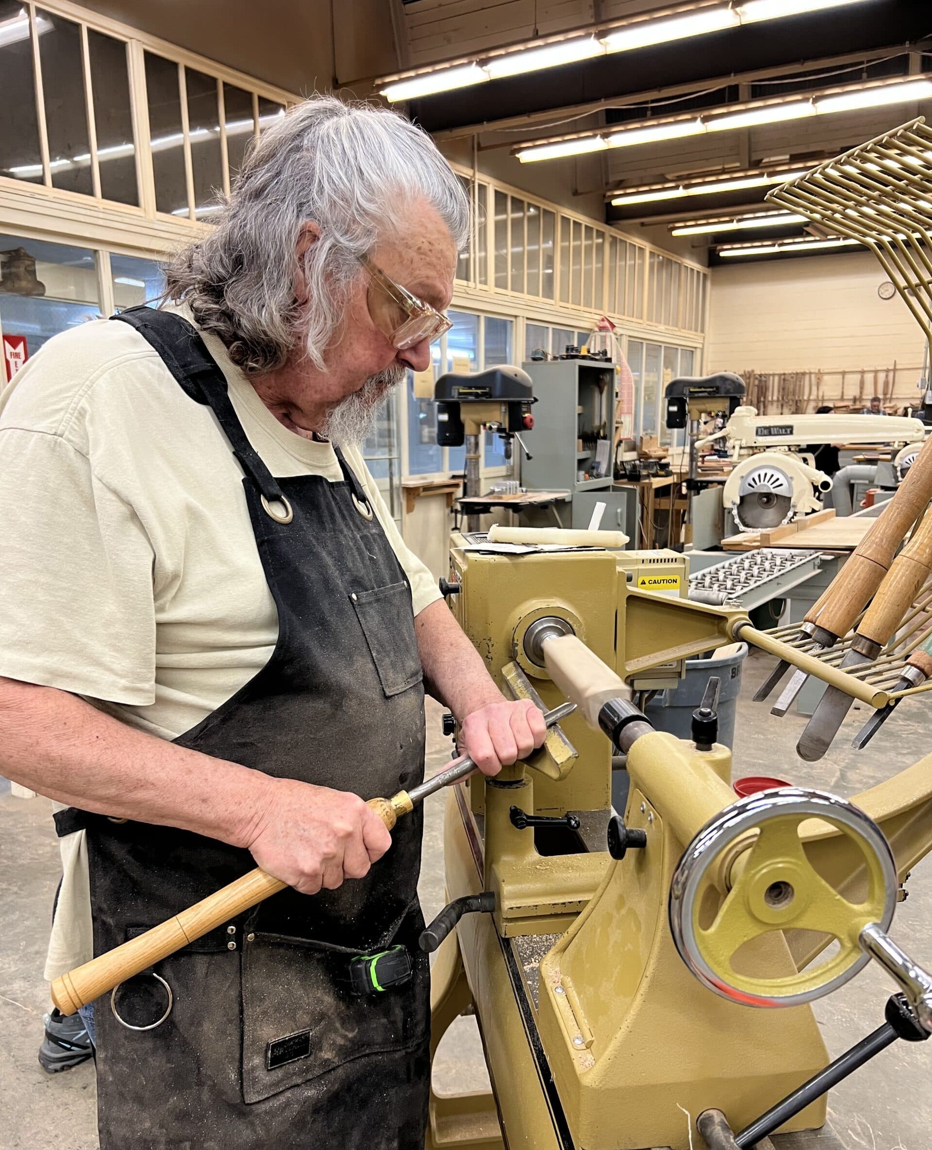 David Cooke, the woodworking professor of the Westervelt Program, demonstrating the use of the lathe