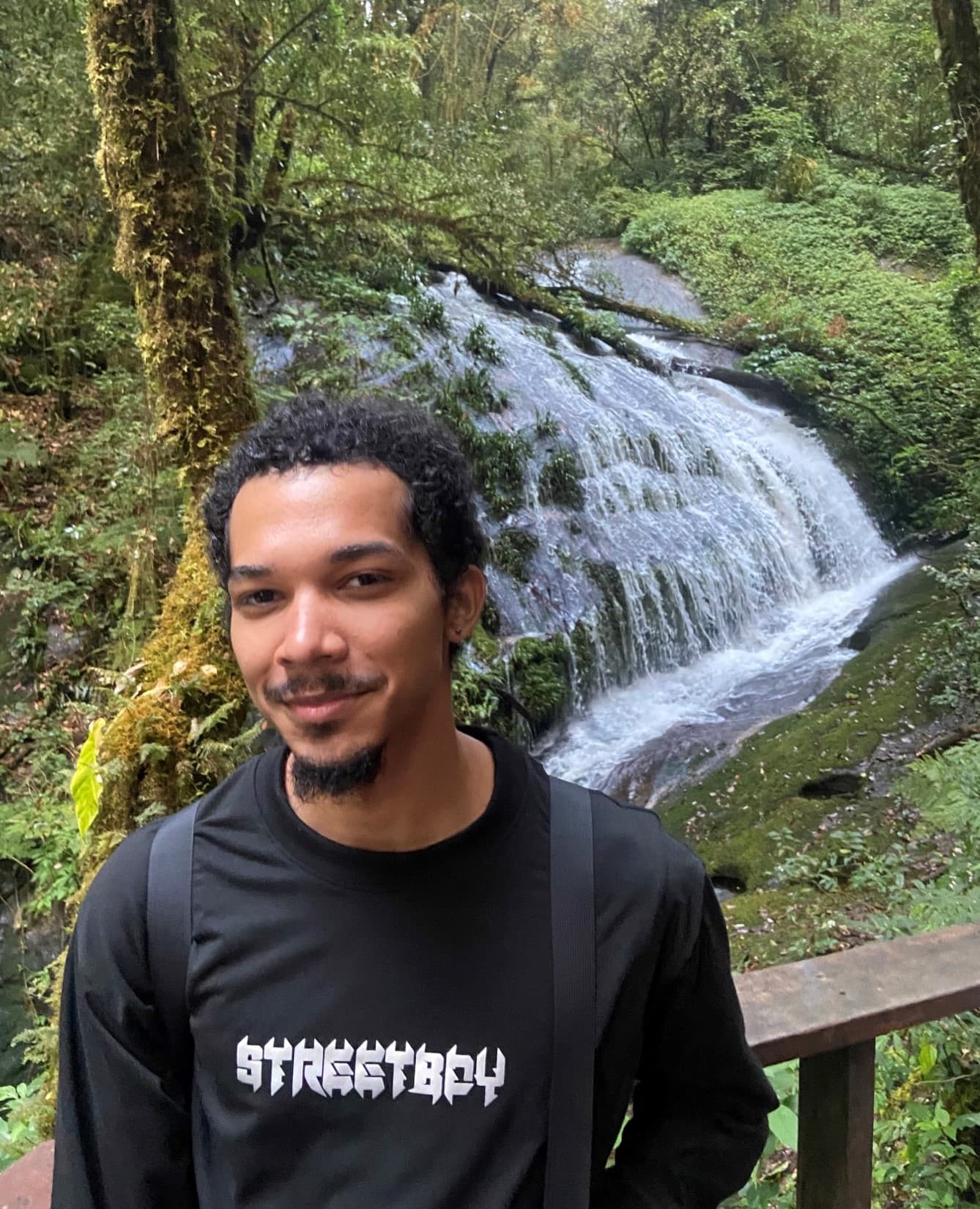 Student in front of waterfall