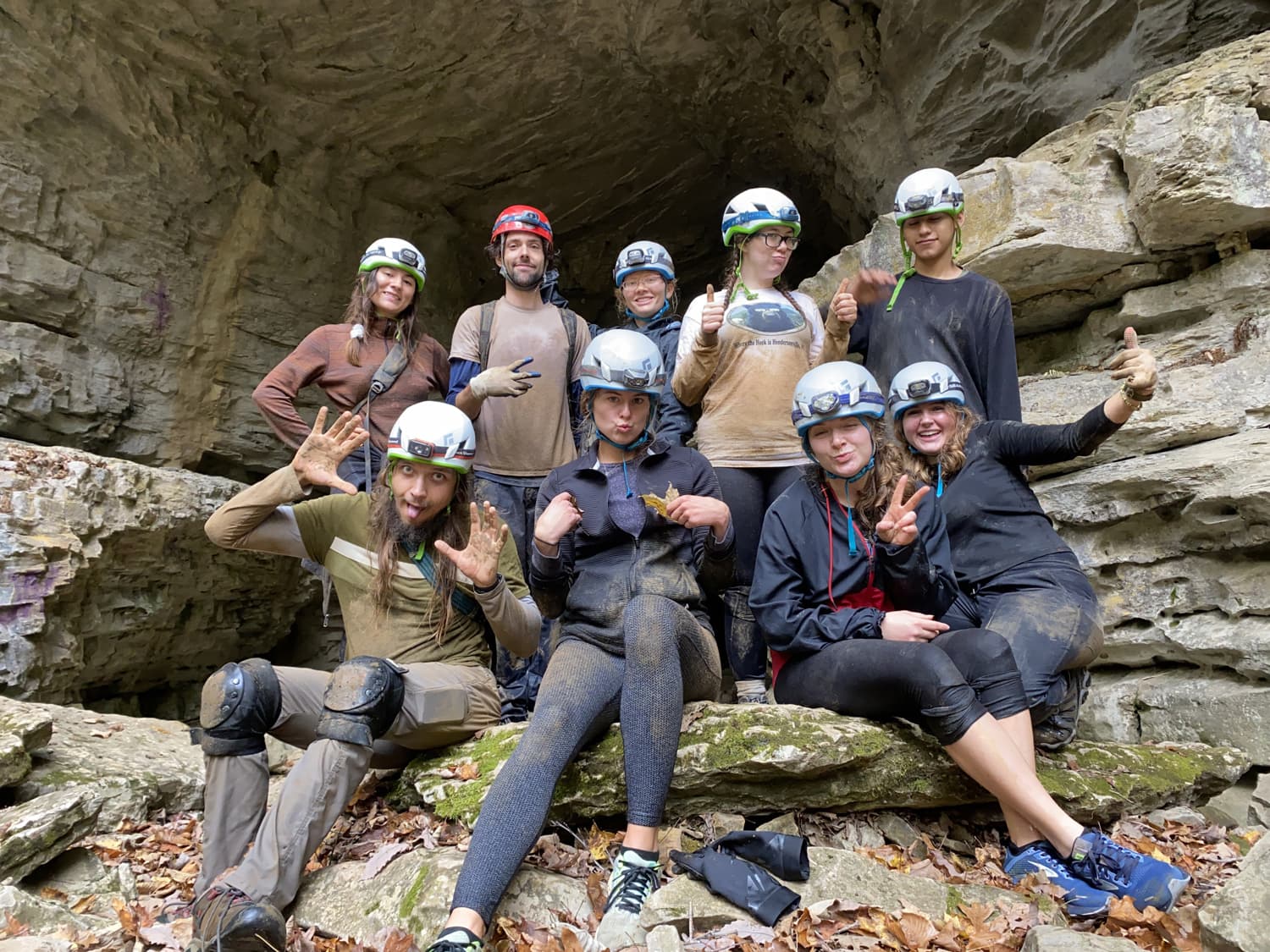 Group photo in front of a cave entrance