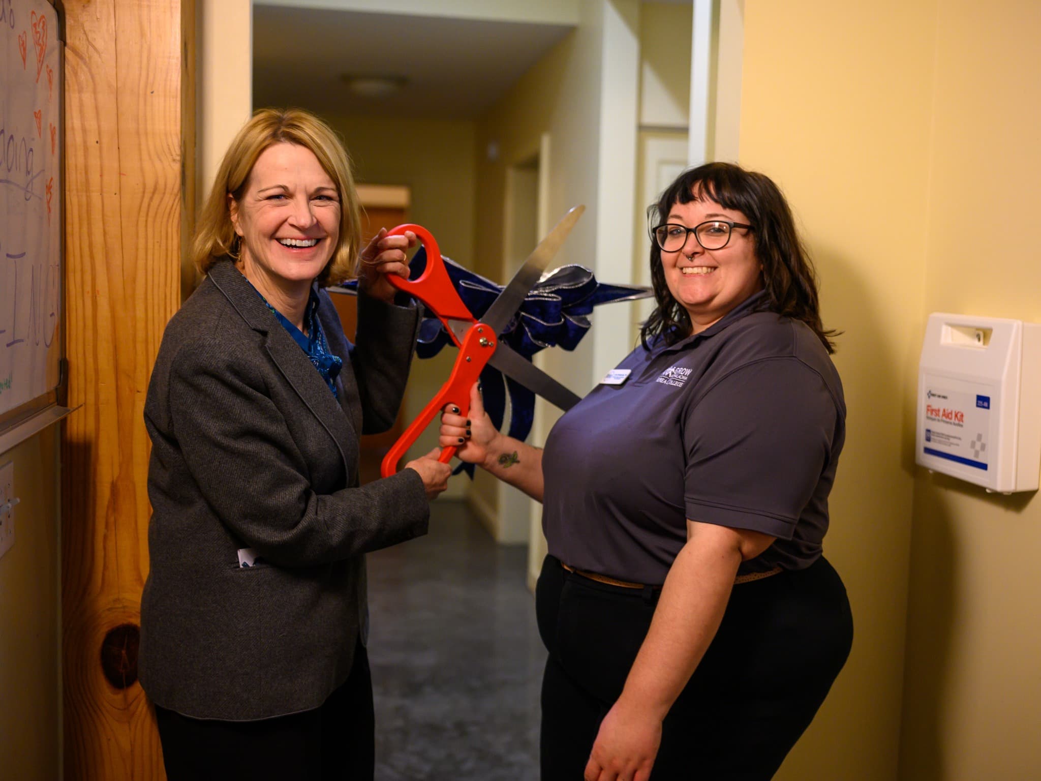 Dr. Nixon and staff Lara cut the ribbon of the B-mart located in the EcoVillage.